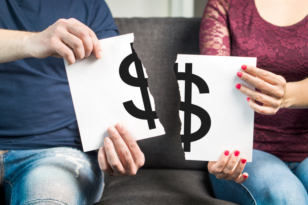 Man and woman holding torn dollar table