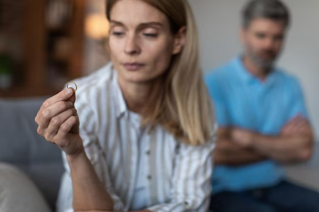 Upset woman holding a ring in her hands